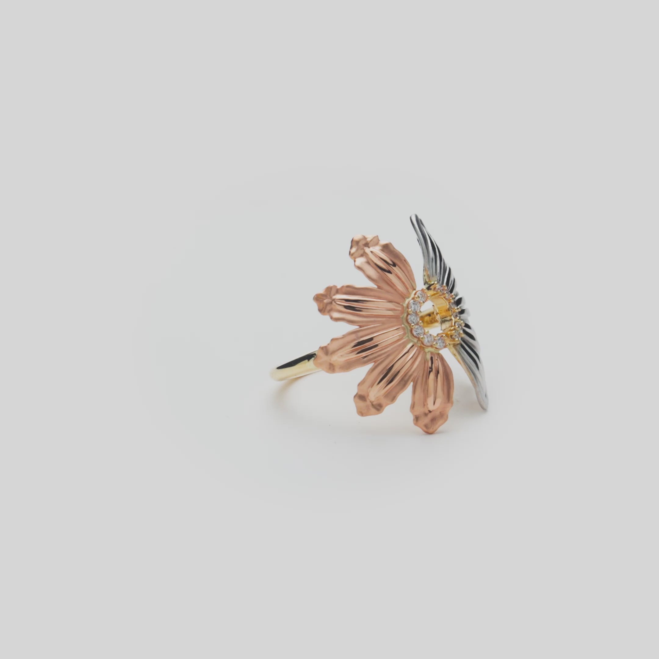 Beach & Mountain Naupaka Ring in Tri Color Gold with Diamonds on a white turntable