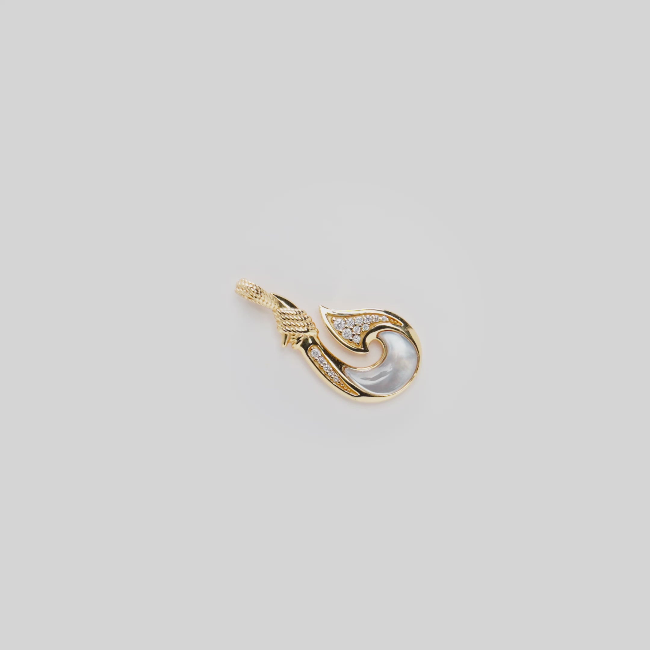 Video showcasing the Fish Hook Mother of Pearl Pendant in 14k Yellow Gold with Diamonds
