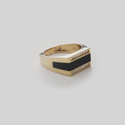 Close up video of Hawaiian Black Coral Ring in Gold with Diamonds on white turntable 