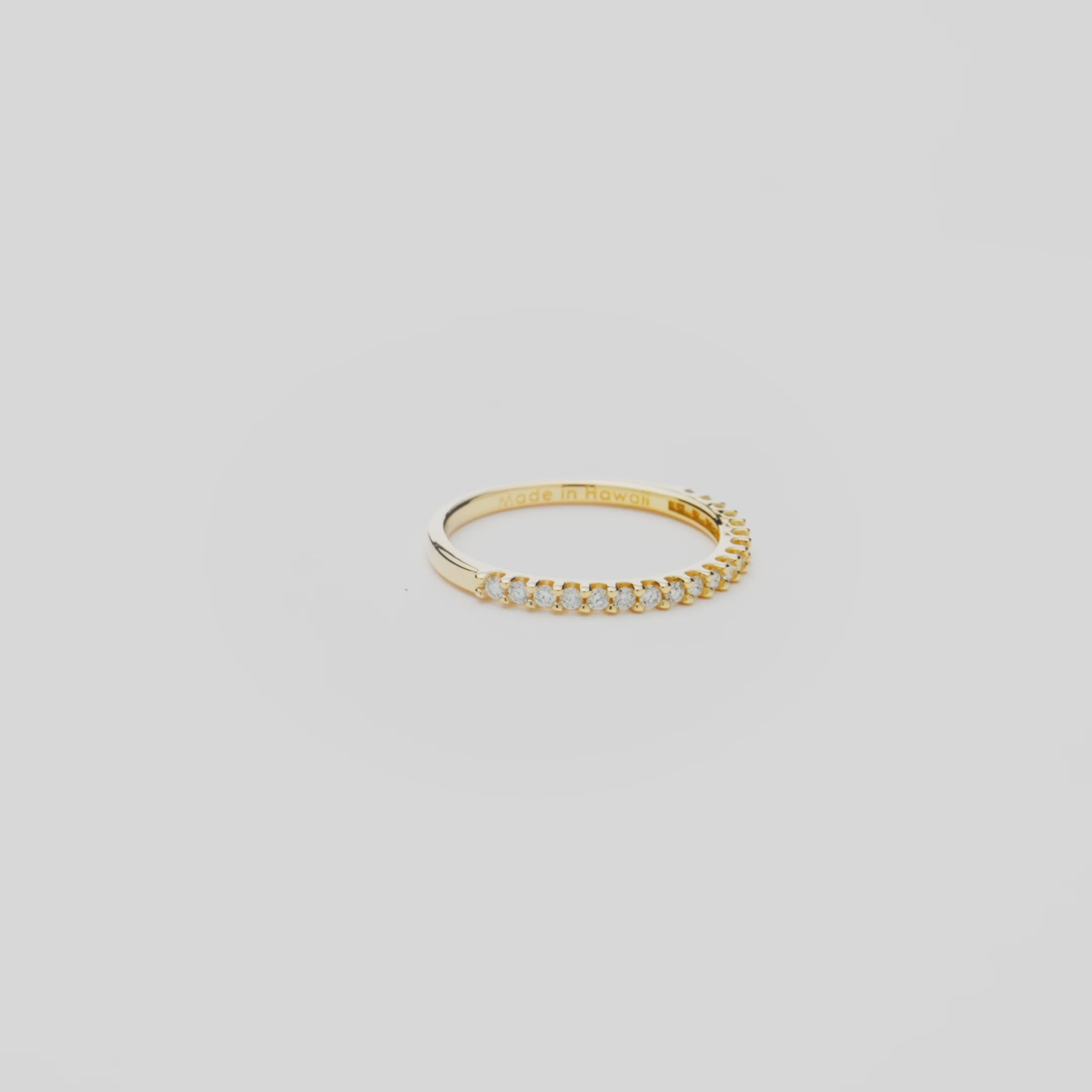 Anniversary Ring in Gold with Diamonds on a white turn table