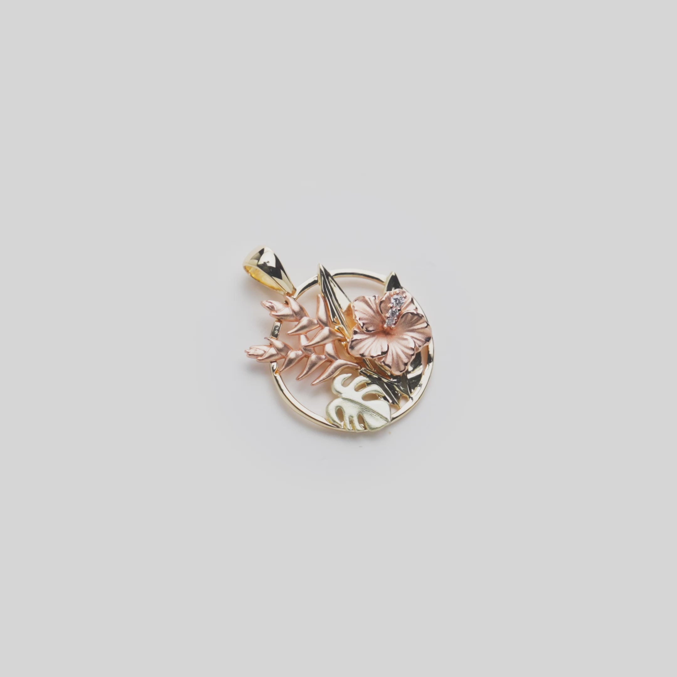 Video showcasing Hibiscus, Heliconia and Monstera Pendant in Tri-color gold with diamonds 