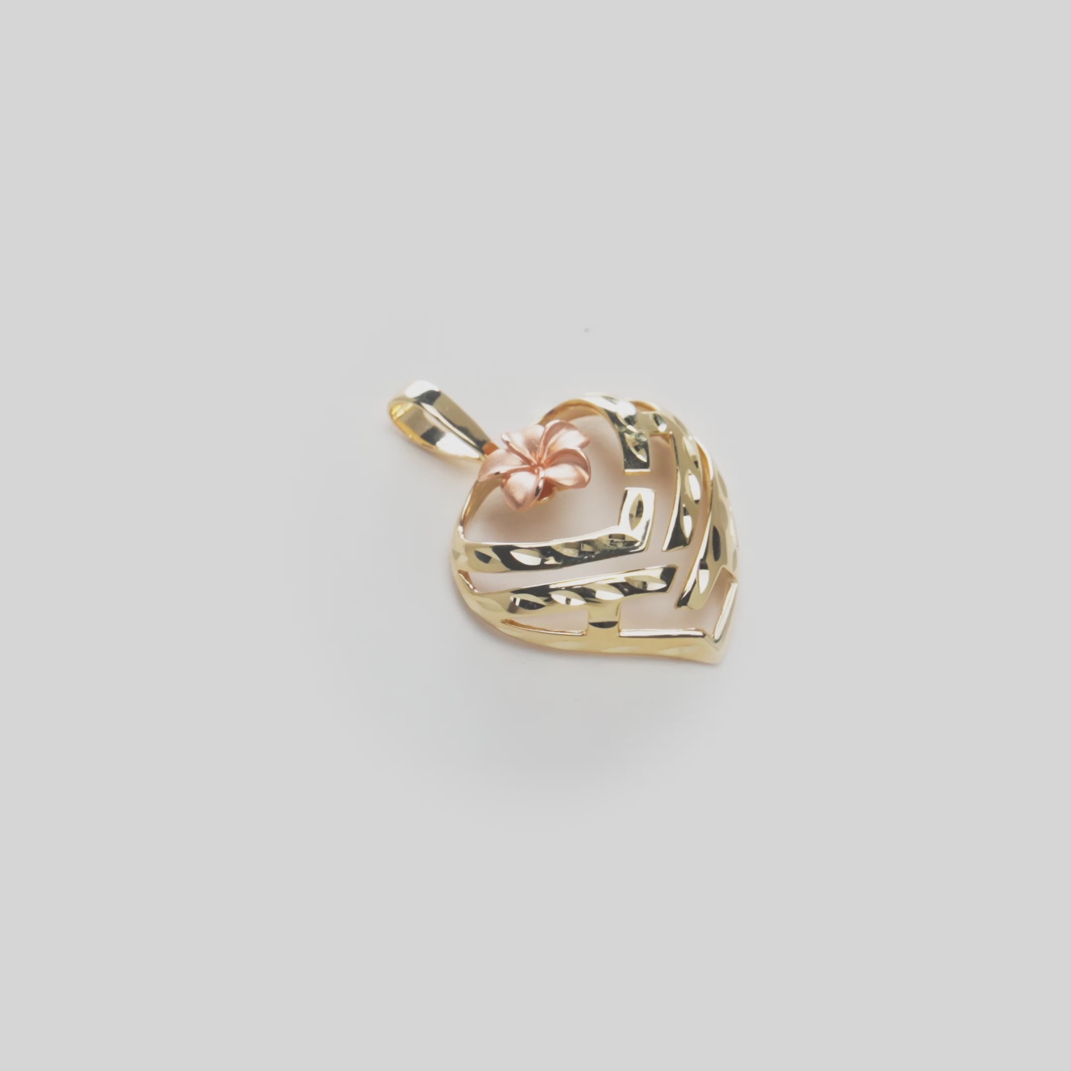 Video of the Aloha Heart Pendant in 14k Yellow Gold with rose gold plumeria accent on a Turn Table