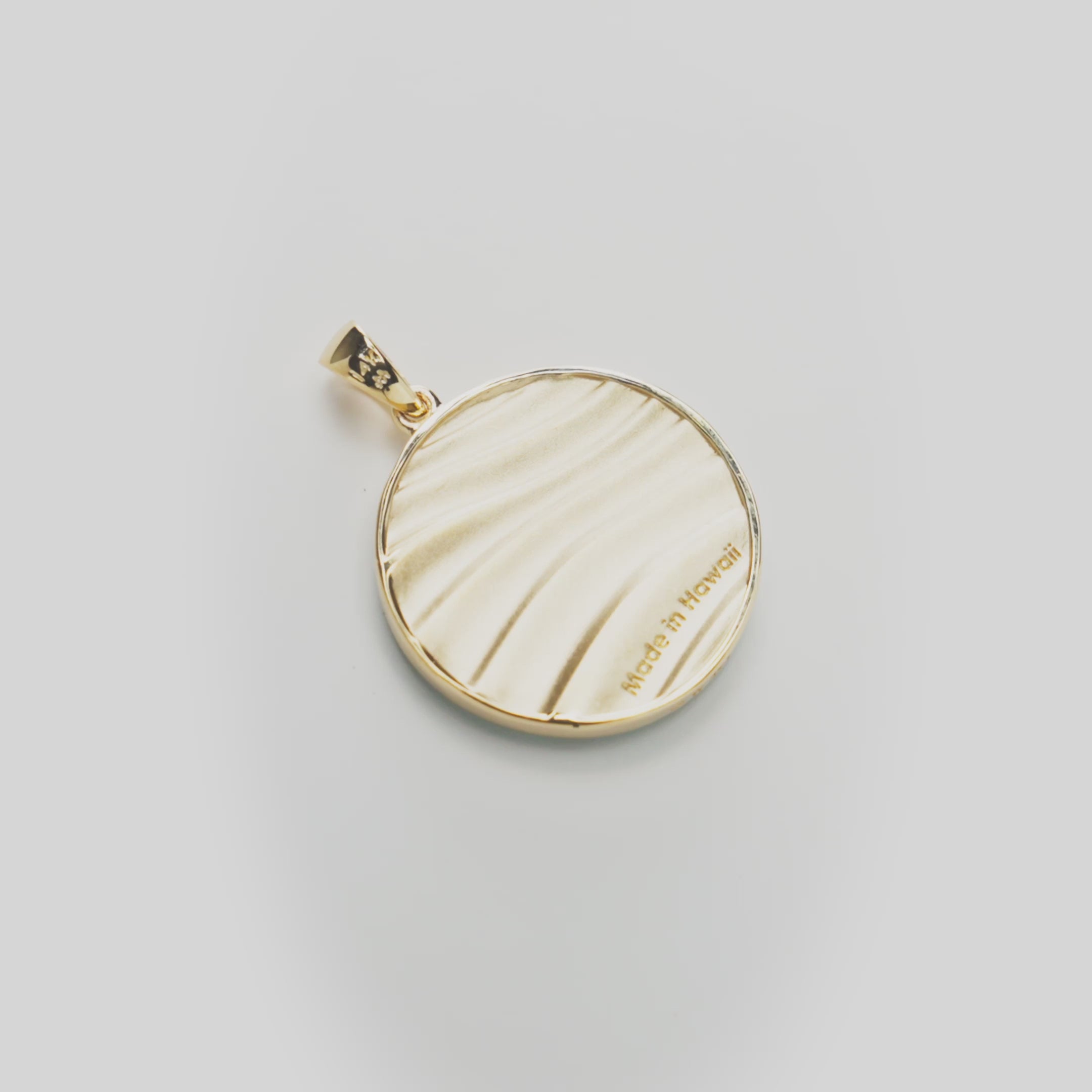 Backside of Ocean Sand Turquoise Pendant in Gold on white turntable