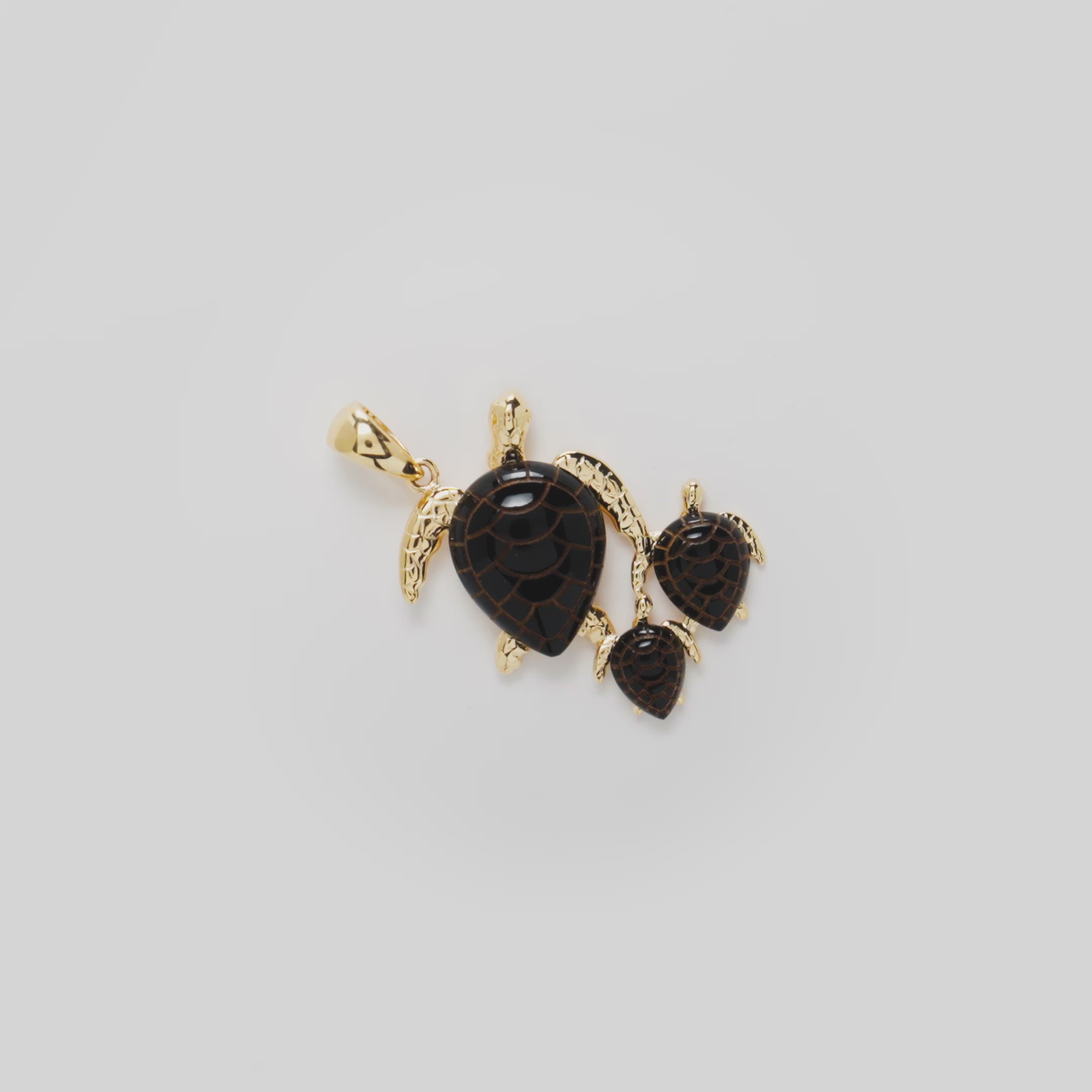 Video showcasing the 29mm Honu Black Coral Pendant in 14k Yellow Gold on a turn table