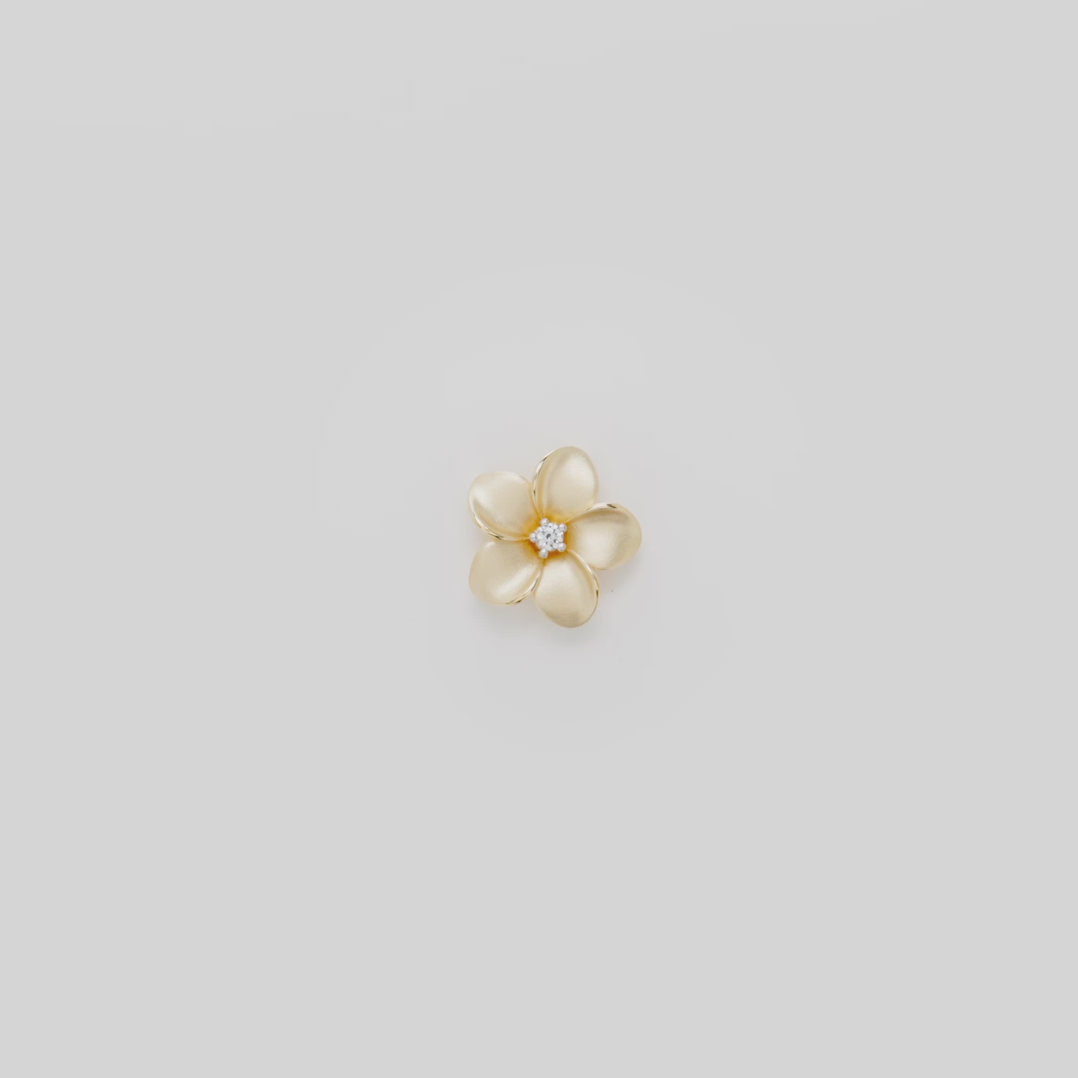 Video showcasing the 13mm Plumeria Pendant in 14k Yellow Gold with Diamond on a turn table