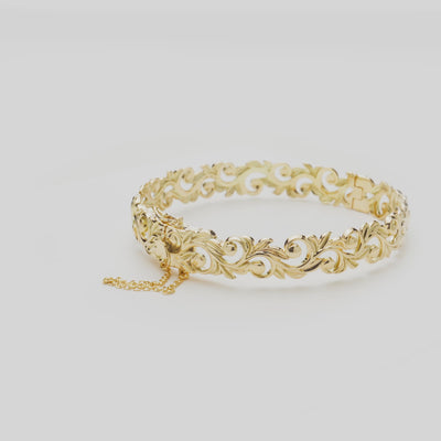 Living Heirloom Hinge Bracelet in Gold on a white turn table