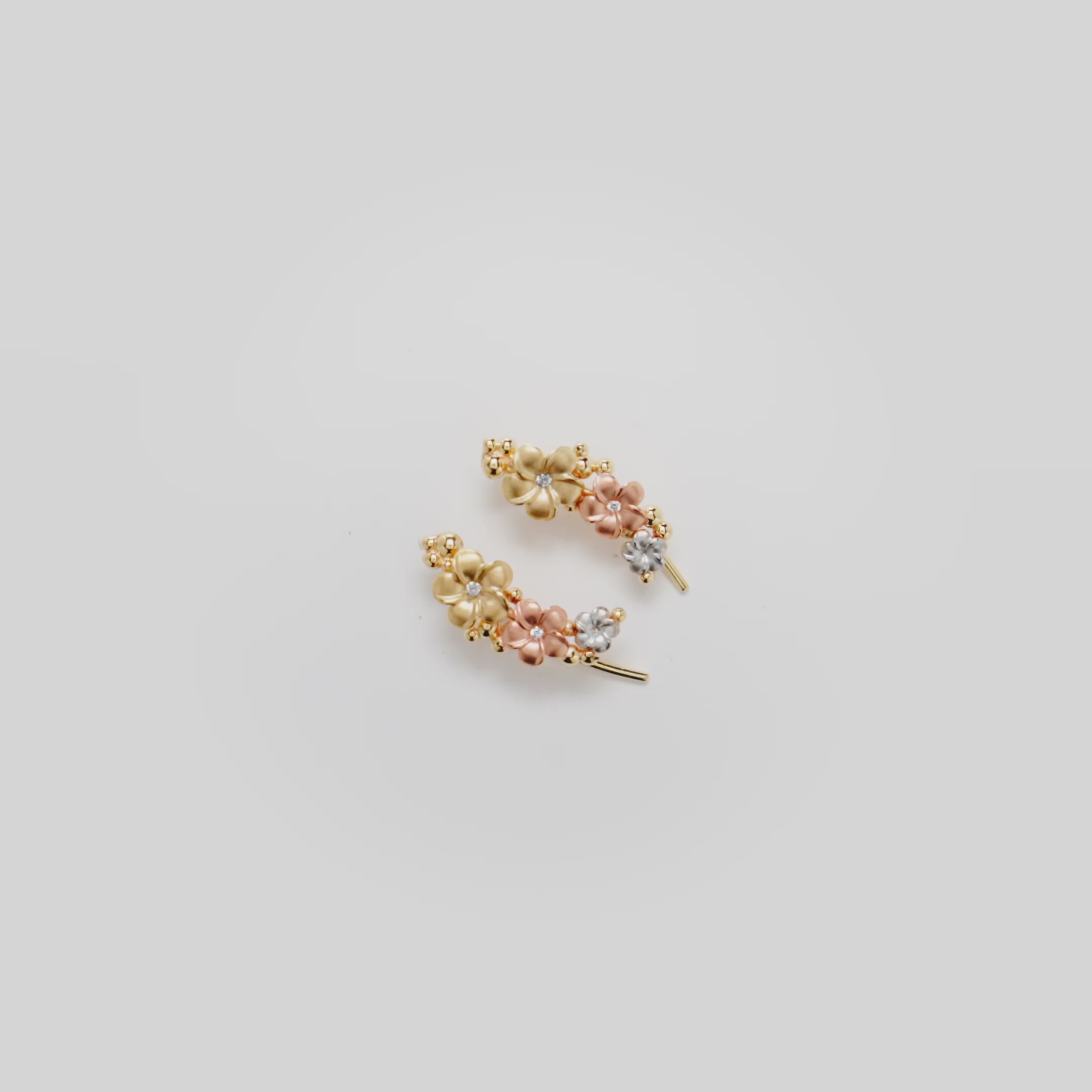 Video showcasing the Plumeria Climber Earrings in Tri Color Gold with Diamonds
