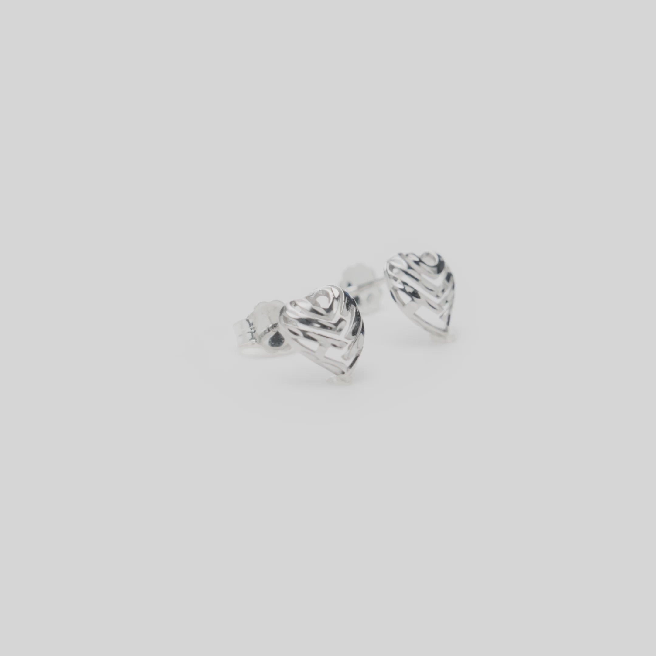 Video of Aloha Heart Earrings in Sterling Silver on a white turntable