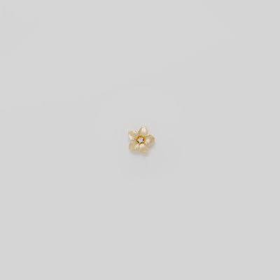 Video showcasing the 9mm Plumeria Pendant in 14k Yellow Gold with Diamond on a turn table