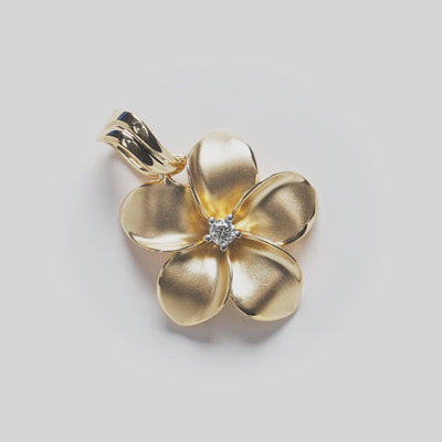 Video close-up of 14k Yellow Gold Plumeria Pendant with Diamond in the center