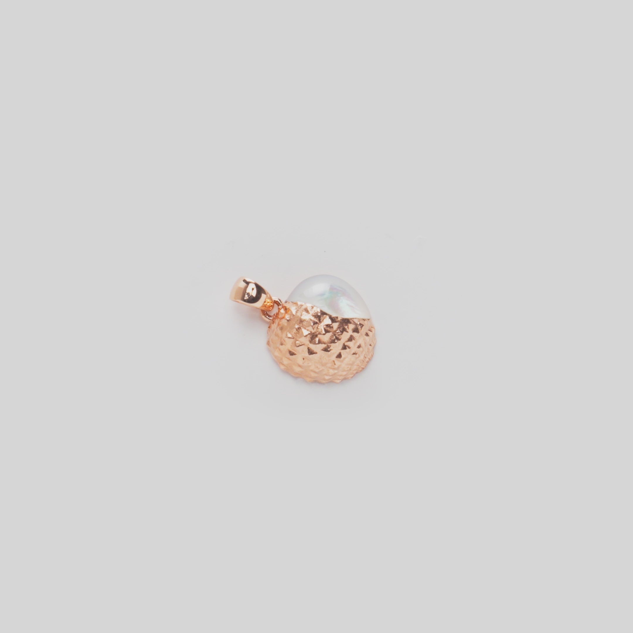 Close-up video of a Cute Fruits Lychee Mother of Pearl Pendant in 14k rose gold rotating on a white background