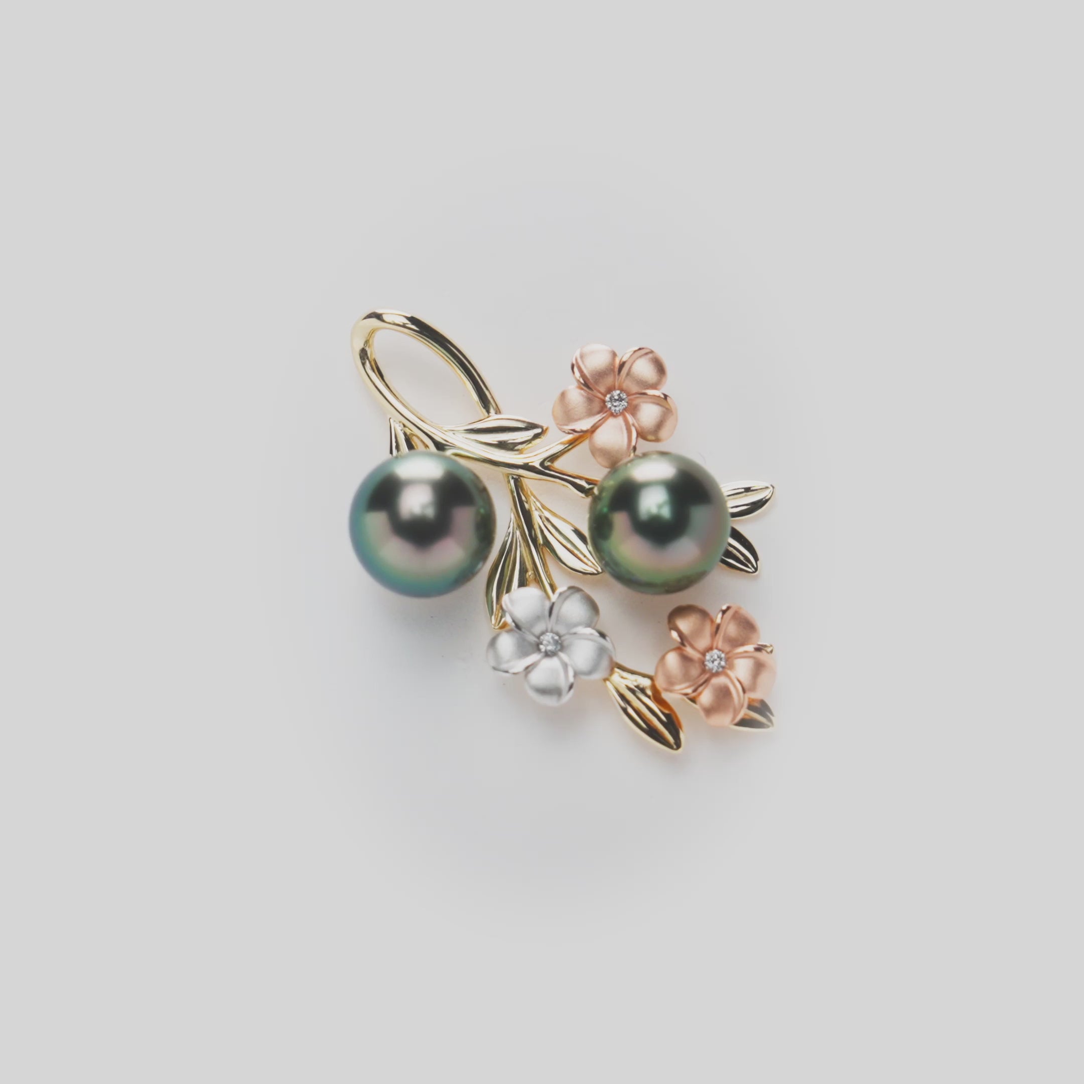 36mm Pearls in Bloom Plumeria Tahitian Black Pearl Pendant in Tri Color Gold with Diamonds on a white turntable