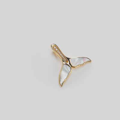 Sealife Whale Tail Mother of Pearl Pendant in Gold with Diamonds on a white turn table