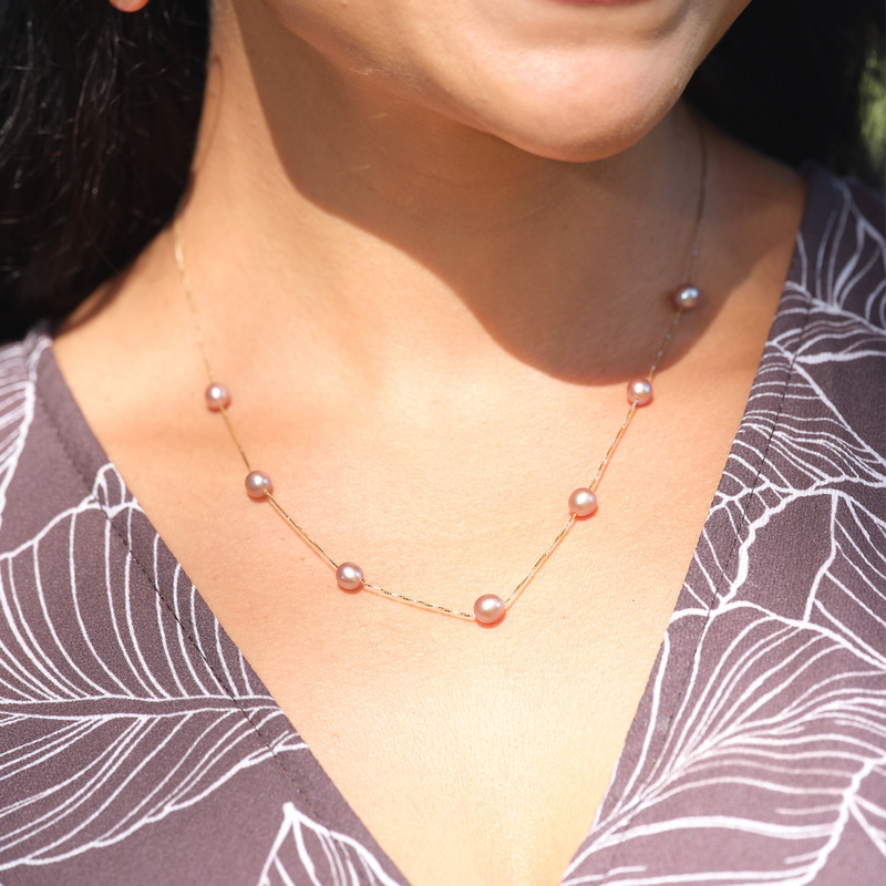A woman's chest with a Mixed Freshwater Floating Pearl Necklace in Gold - 5-6mm - Maui Divers Jewelry
