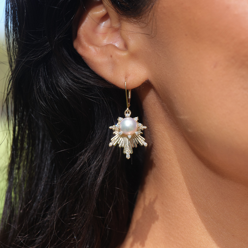 A woman's ear with E Hoʻāla Akoya White Pearl Earrings in Gold with Diamonds - Maui Divers Jewelry