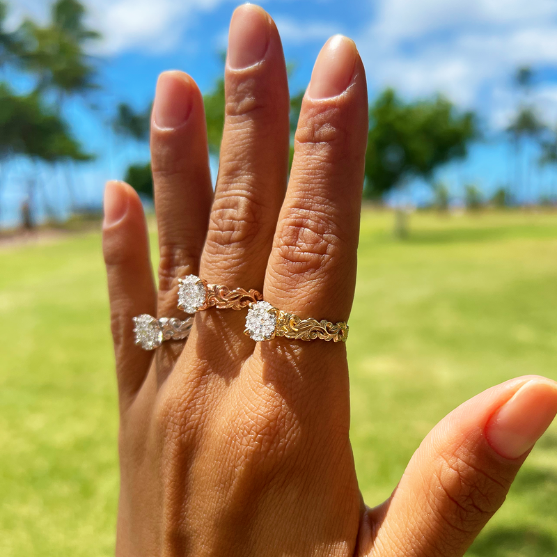 A woman's hand wearing a Hawaiian Heirloom Engagement Ring in White Gold, Yellow Gold and Rose Gold with Diamonds - Maui Divers Jewelry
