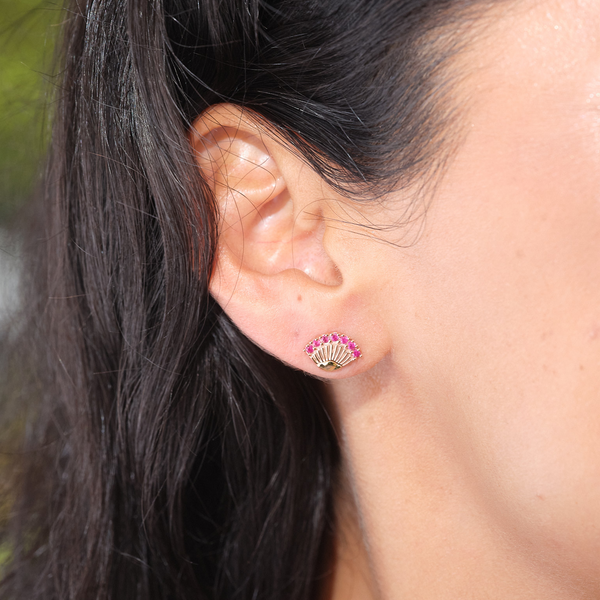 A woman's ear with Ohia Lehua Ruby Earrings in Two Tone Gold - 11mm -0 Maui Divers Jewelry