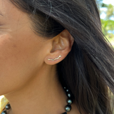 A womanʻs ear with a Heritage Climber Earrings in Gold - Maui Divers Jewelry