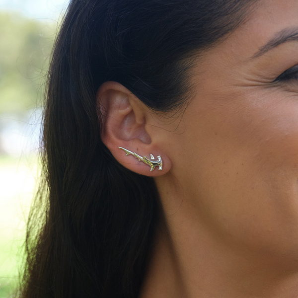 A woman's ear with a Hammerhead Shark Climber Earrings in White Gold - 26mm - Maui Divers Jewelry