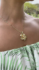 Video of a woman wwearing a Plumeria Pendant in gold with Diamond - 28mm - Maui Divers Jewelry