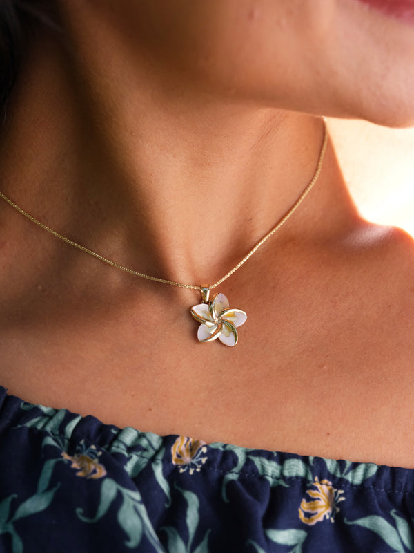 A woman wearing a Plumeria Mother of Pearl Pendant in Gold - 18mm-Maui Divers Jewelry