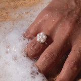 A woman's hand in the water wearing a Tiny Bubbles White Freshwater Pearl Ring in Gold with Diamonds - Maui Divers Jewelry