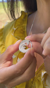 Video of a woman wearing a Nalu Pendant in White Gold with Diamonds - 26mm - Maui Divers Jewelry