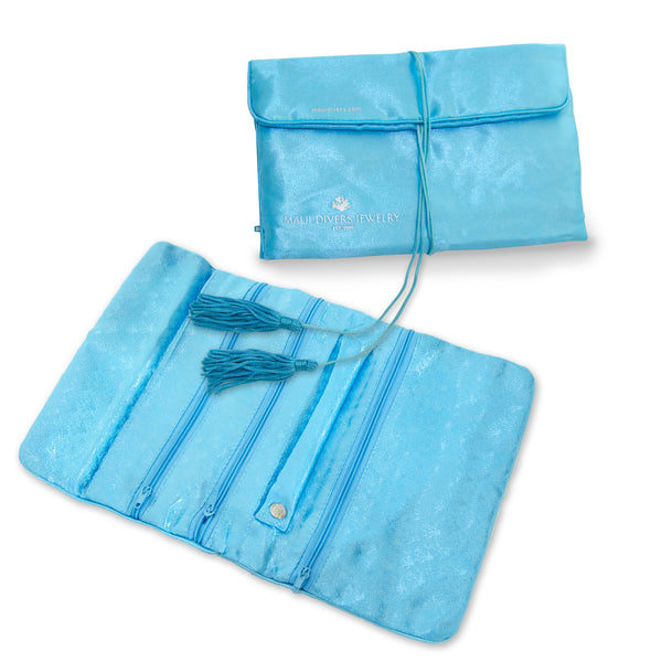 	a Maui Divers Jewelry Silk Travel Roll pouch with a tassel.